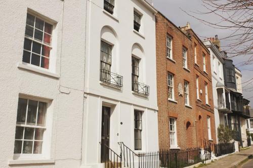 a white building on a street with brick buildings at Stanhope House in Hastings