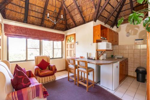 a kitchen with a table and a counter top at Montagu Little Sanctuary - Hot Spring Access at Special Rate in Montagu