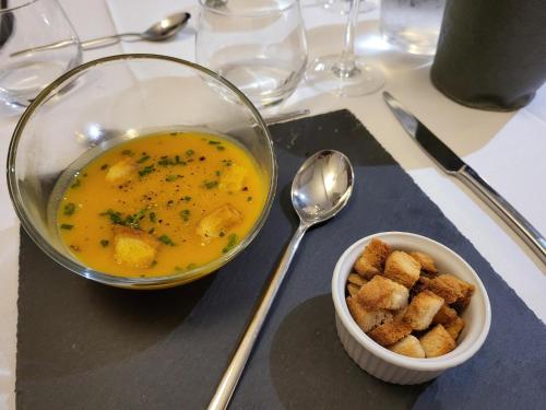 a bowl of soup next to a bowl of food at Kyriad Tours - Joué-Lès-Tours in Joue-les-Tours