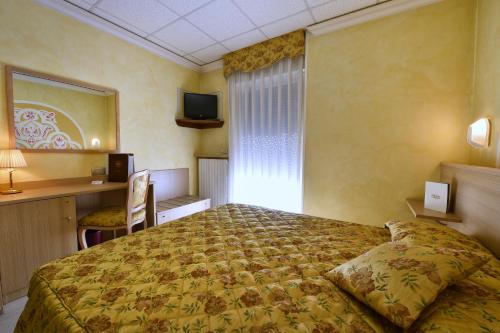 a hotel room with a bed and a window at Stella Alpina Hotel e Ristorante in Druogno