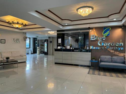 a lobby with couches and a counter in a store at Blue Garden Resort Pattaya in Jomtien Beach
