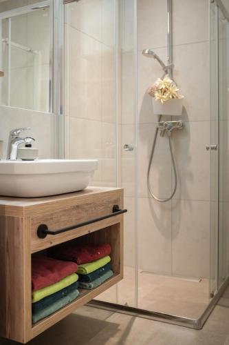 a bathroom with a sink and a shower at Miglurahof in Adnet