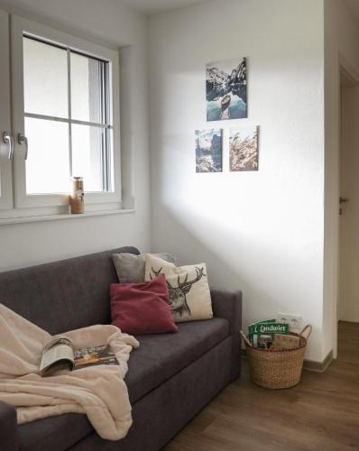 a living room with a couch and a window at Miglurahof in Adnet