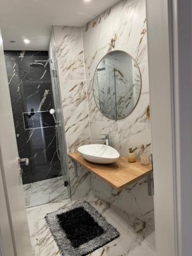 a bathroom with a sink and a mirror at APARTMENT MEMORY in Zadar