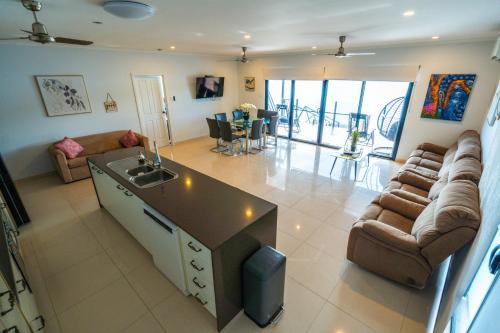 a living room with a couch and a table at Bungalow 58 Lake Bennett Darwin in Lake Bennett