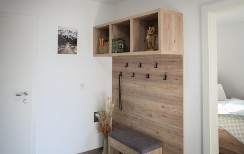 a room with a wooden wall with a bench and a bed at Miglurahof in Adnet