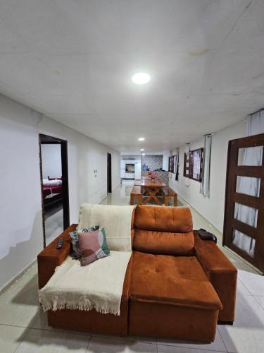 a living room with a couch and a table at Casa de praia 1 in Goiana