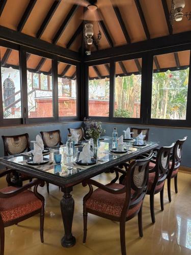 a dining room with a large table and chairs at Brij Paraiso Saligao, Goa - An Indo-Portuguese Villa in Calangute