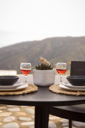 a table with two glasses of wine on it at Elirion Luxury Home II in Kamária