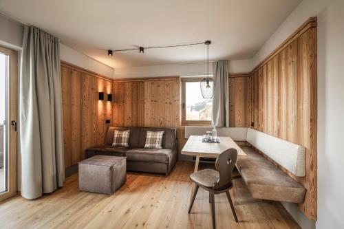 a living room with a table and a couch at Apartment Lodge Gasserhof in Bressanone