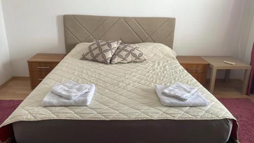 a bedroom with a bed with two towels on it at BT Lux apartment 2 in Skopje