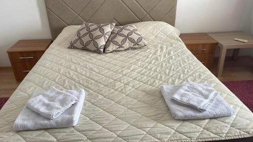 a bed with two towels on top of it at BT Lux apartment 2 in Skopje