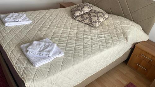 a bed with two towels on top of it at BT Lux apartment 2 in Skopje
