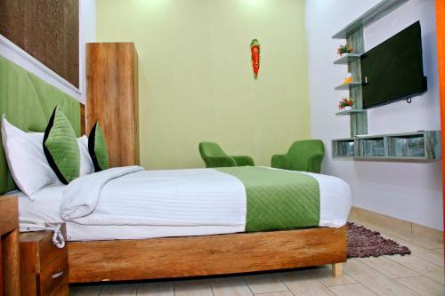 a bedroom with a bed and a flat screen tv at Red Leaf Hotels in Chandīgarh