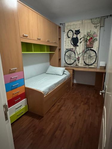 a small bedroom with a bed and a bike on the wall at Playa Isomara in Puerto del Rosario