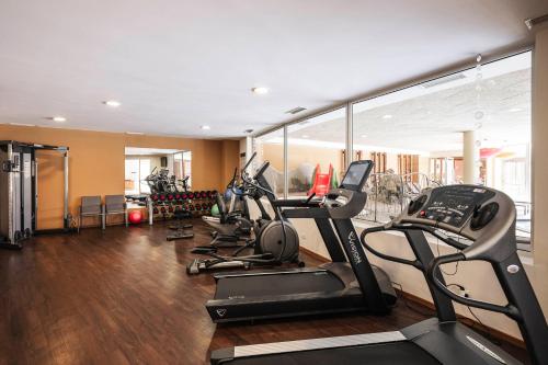a gym with several cardio machines in a room at Apartment Lodge Gasserhof in Bressanone