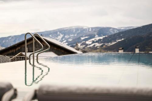 a hot tub with a view of a mountain at Apartment Lodge Gasserhof in Bressanone