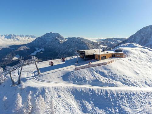 a ski lodge on top of a snow covered mountain at Appartementhaus Charisma in Fieberbrunn