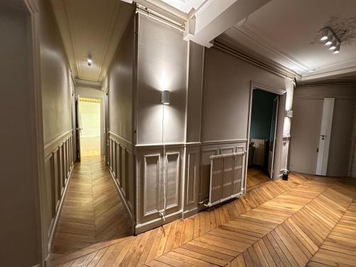 an empty room with a wooden floor and a hallway at Maison Privée Saint-Germain-des-Prés in Paris
