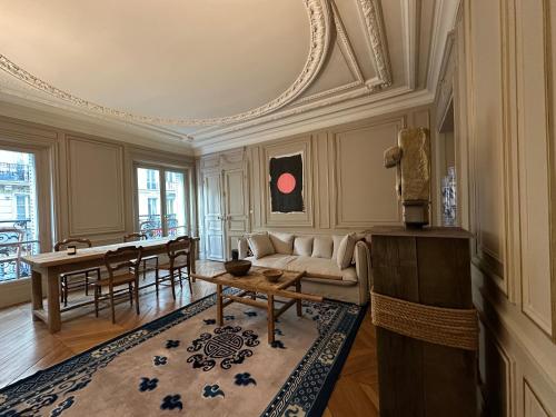 a living room with a couch and a table at Maison Privée Saint-Germain-des-Prés in Paris