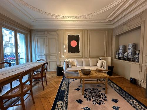 a living room with a couch and a table at Maison Privée Saint-Germain-des-Prés in Paris