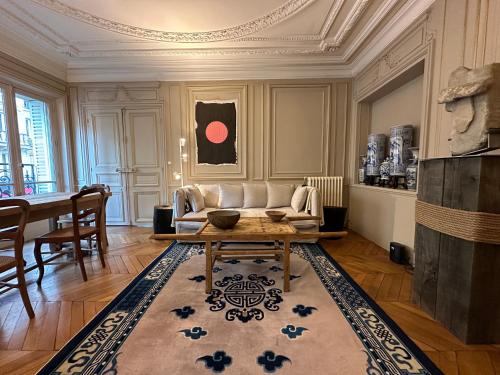 a living room with a couch and a table at Maison Privée Saint-Germain-des-Prés in Paris