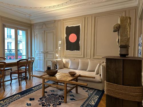a living room with a couch and a table at Maison Privée Saint-Germain-des-Prés in Paris