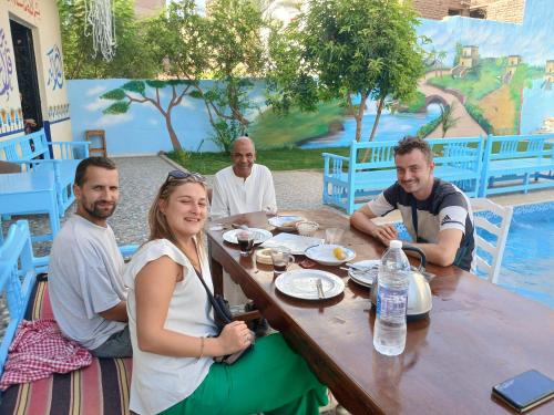 a group of people sitting at a table at Luxor View Hostel in Luxor