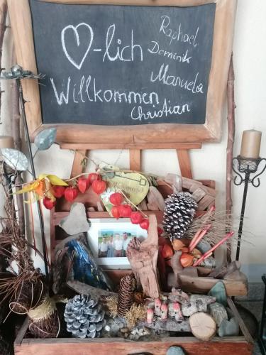 a chalkboard with a sign and a bunch of vegetables at Appartementhaus Charisma in Fieberbrunn