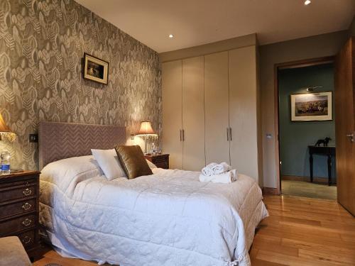 a bedroom with a large bed in a room at Hazelwood Country House in Adare