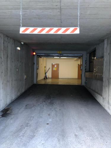 an empty parking garage with a red and white ceiling at Sonniges Bergblick-Appartement in Damuls