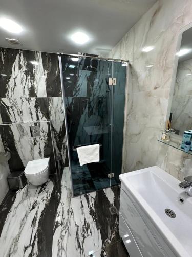 a bathroom with a sink and a toilet and a shower at Hotel Roma & Tours in Yerevan
