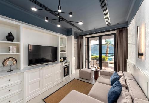 a living room with a couch and a tv at Casa Nonna Bodrum - Adult Only in Bodrum City