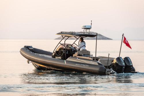 a man in a boat on the water at Casa Nonna Bodrum - Adult Only in Bodrum City