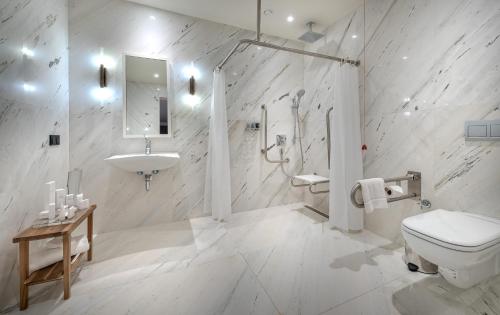 a white bathroom with a toilet and a sink at Casa Nonna Bodrum - Adult Only in Bodrum City