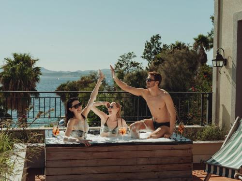a man and two women sitting in a hot tub at Casa Nonna Bodrum - Adult Only in Bodrum City