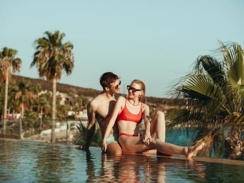 a man and a woman sitting in a swimming pool at Casa Nonna Bodrum - Adult Only in Bodrum City