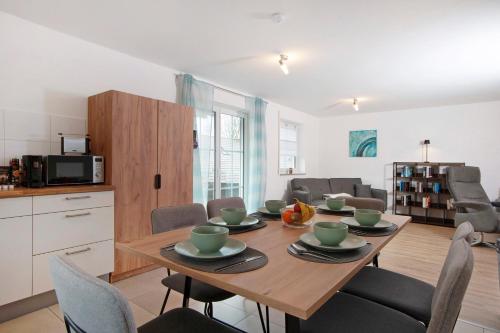 a kitchen and dining room with a wooden table and chairs at Wohnung Sonnentau in Bad Wurzach