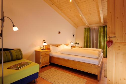 a bedroom with a bed and a couch at Hoarachhof in Innsbruck