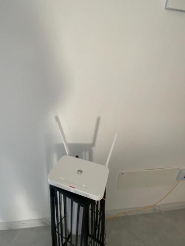a white chair sitting in front of a white wall at Felicidade apartamento Palmarejo Grande in Praia
