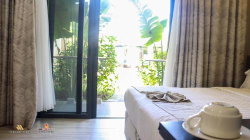 a bedroom with a bed and a sliding glass door at Charchoma Restaurant in Mombasa
