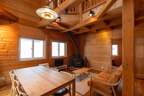 a dining room with a table and a fireplace at en Hakuba in Hakuba