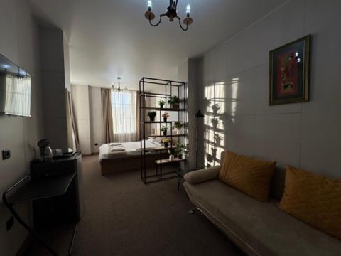 a living room with a couch and a bed at Riva in K'obulet'i