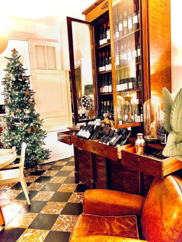 a bar with a christmas tree in a room at Hôtel VCB Ciney Centre-ville in Ciney