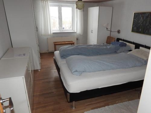 a bedroom with two beds and a window at Engbjerg BnB in Hirtshals
