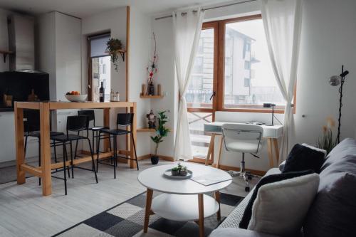 a living room with a couch and a table at Seasons stay Bansko in Bansko