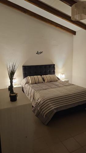 a bedroom with a large bed with two lamps at Casa Montana in Potrero de Garay
