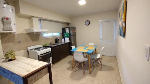 a small kitchen with a table and chairs in it at Departamento 20 in Necochea
