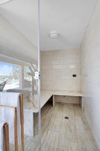 a bathroom with a shower and a glass door at Entrada Suite in Portimão
