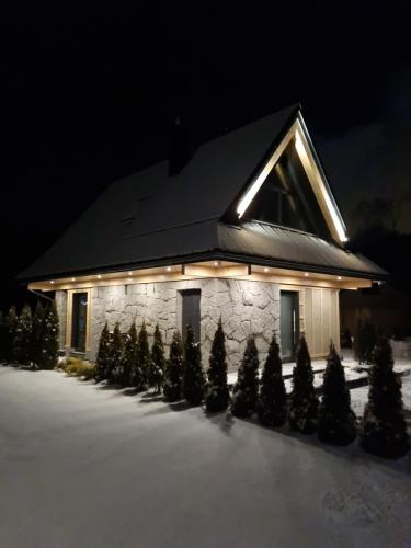 a building with christmas trees in front of it at Osada Maruszyna in Szaflary